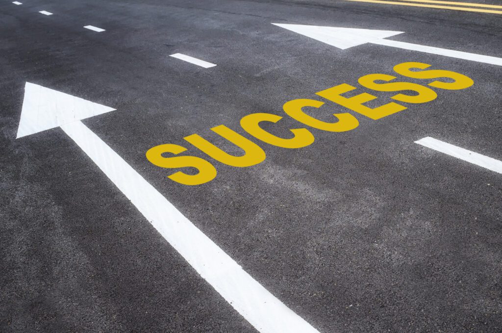 Road with arrows and the word Success